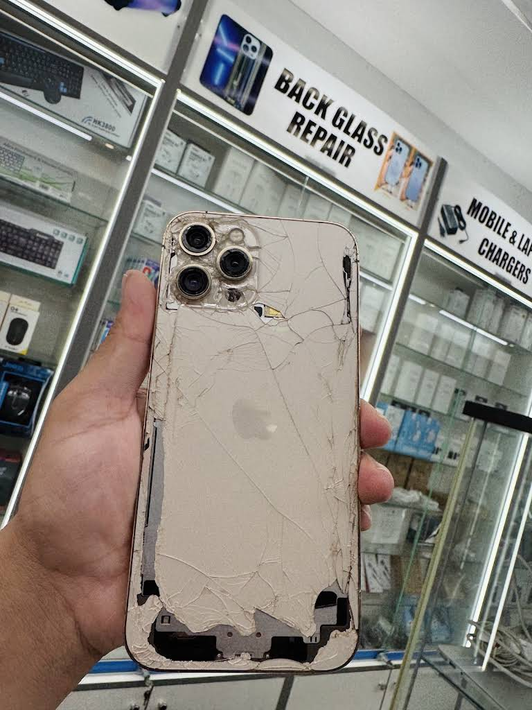 Close-up of an iPhone with shattered back glass brought in by a nearby customer to the PMM Solutions Morden workshop